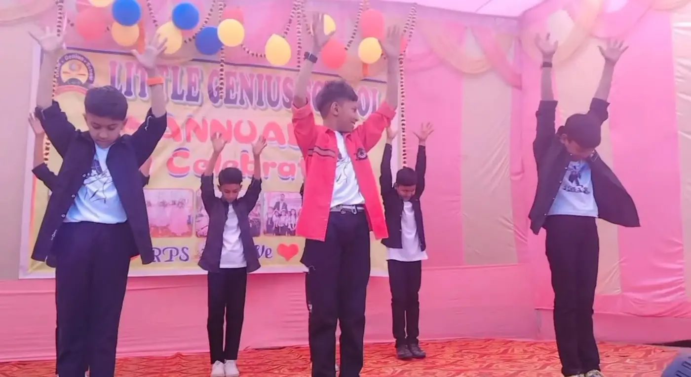 Boys raise their arms together during a stage dance at the annual celebration.